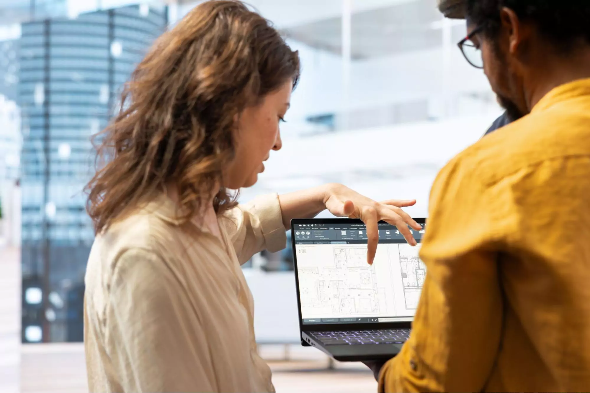 Two coworkers looking at the dashboard of their new productivity software.